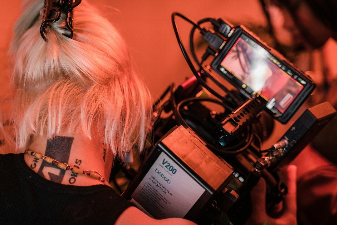 Journalist taking notes next to a recording device during an interview